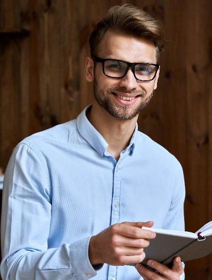 smiling young business man holding planner looking 2022 02 05 07 34 47 utc 1